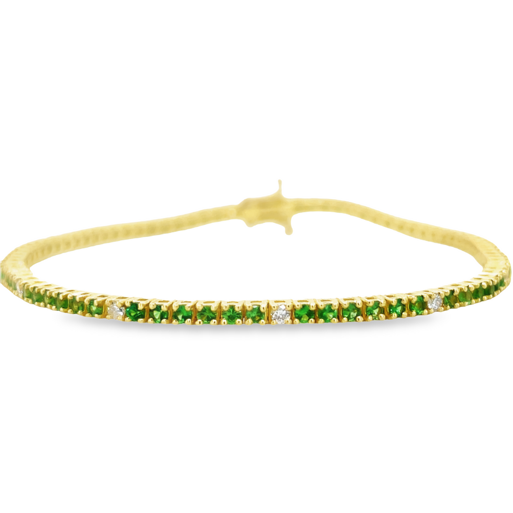 This Tsavorite & Diamond Line Bracelet is an elegant accessory for any occasion. Crafted in 18k yellow gold, this bracelet features stunning Tsavorite garnet stones and round diamonds, creating a unique look. With its eye-catching design, this bracelet is the ideal way to add a touch of sophistication to your style.