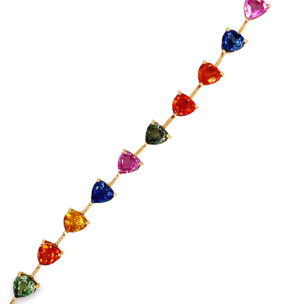 This beautiful 18k rose gold bracelet features a heart-shaped multi-colored sapphire totaling 12,007 cts. It's the perfect way to make a glamorous statement with sophistication.