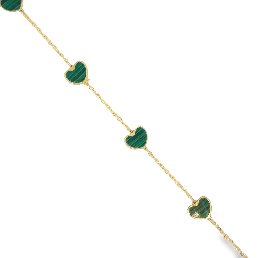 This elegant 14k yellow gold bracelet features five intricately detailed malachite hearts and a secure lobster clasp. The clovers measure 7.0 mm in size and the bracelet itself exudes sophistication and style.   