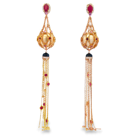 Front view of These one-of-a-kind 18k yellow gold long drop earrings feature an intricate mesh design, extending 4 inches for a striking presence. Adorned with 13.50 mm cultured pearls, pear-shaped rubies, and vibrant sapphires, they combine classic luxury with contemporary artistry, perfect for making an unforgettable statement.