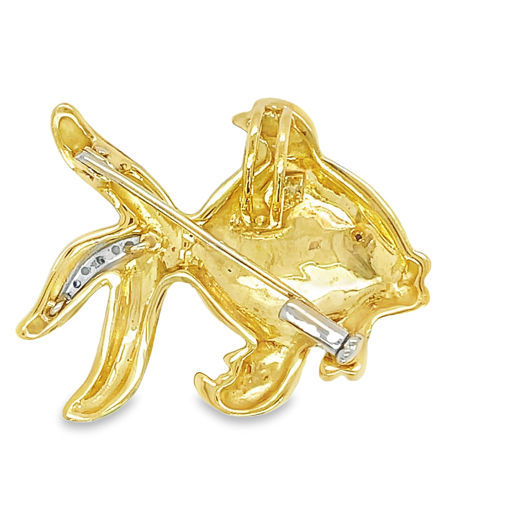 "Add a touch of elegance to any outfit with our Italian Made Enamel & Diamond Fish Brooch! Handcrafted with 18k Italian yellow gold and a sparkling round diamond, this versatile piece can be worn as a brooch or pendant. With its beautiful hand-painted enamel colors, it's sure to catch the eye. Perfect for any occasion!"