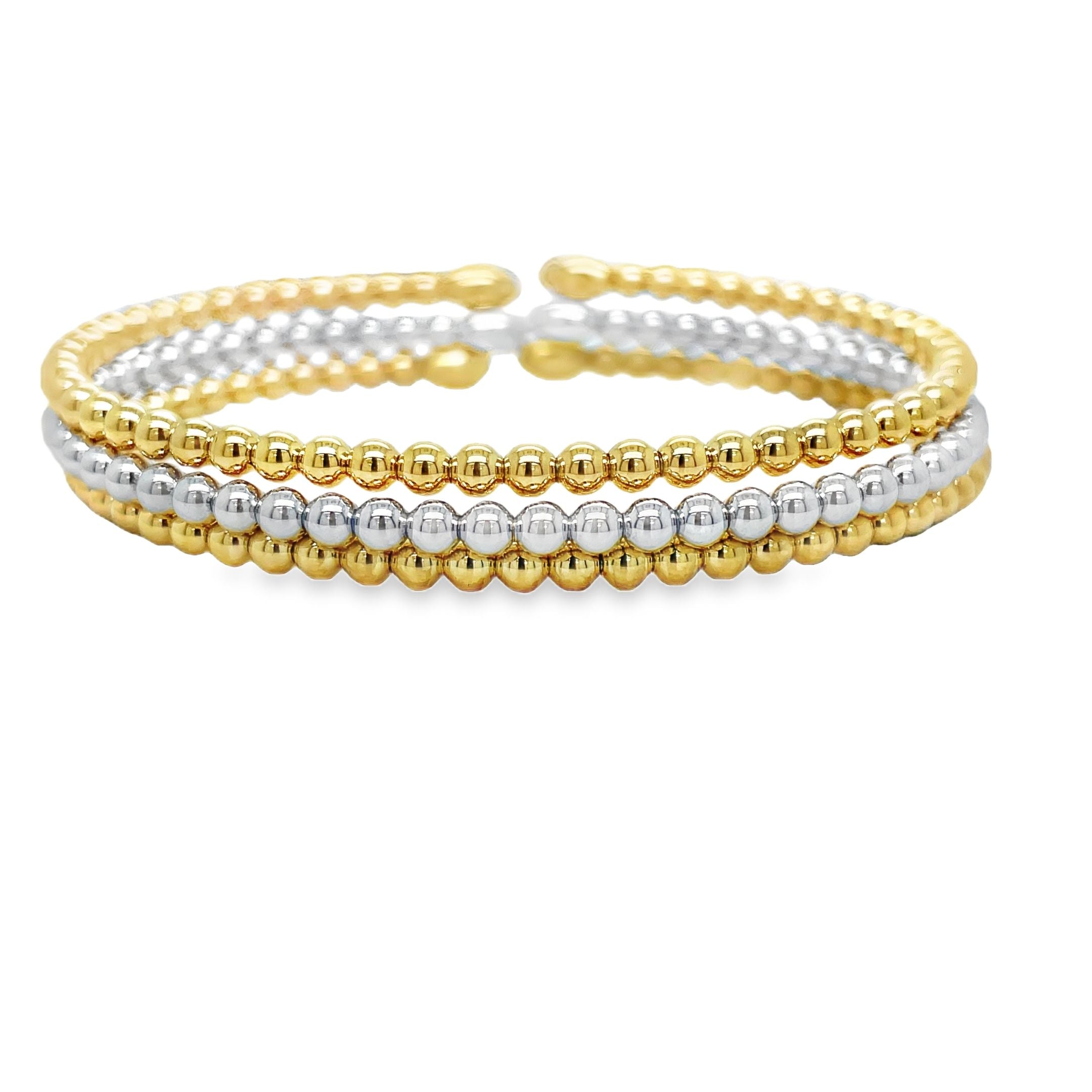 Indulge in pure elegance with our 18k Italian Yellow Gold Bead Bangle Bracelet. Handcrafted in Italy, this exquisite piece showcases the finest quality of 18k yellow gold, featuring a stunning bead style design. Part of our exclusive bangle collection, this bracelet effortlessly combines white and yellow gold for a truly sophisticated and luxurious look. Elevate your jewelry collection with this timeless treasure.