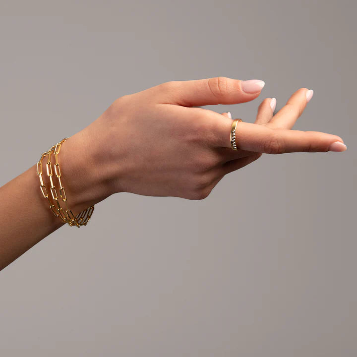 ndulge in luxury with our Italian made triple paperclip bracelet. Crafted from sterling silver and plated in elegant yellow gold, it boasts a secure lobster catch and unique paperclip link design. Add a touch of sophistication to any outfit with this exclusive piece.