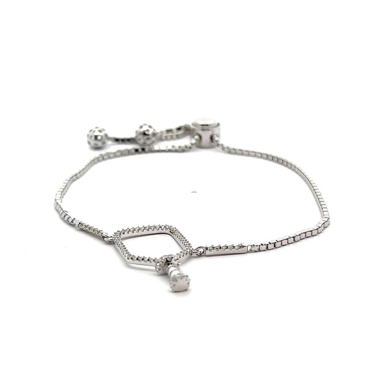Crafted from high-quality sterling silver, this Pickleball Bangle Bracelet is a must-have accessory for any pickleball enthusiast. Its sleek design is both stylish and functional, with a sizeable wrist that ensures a comfortable fit for all-day wear. Show off your love for the game with this stunning bracelet.