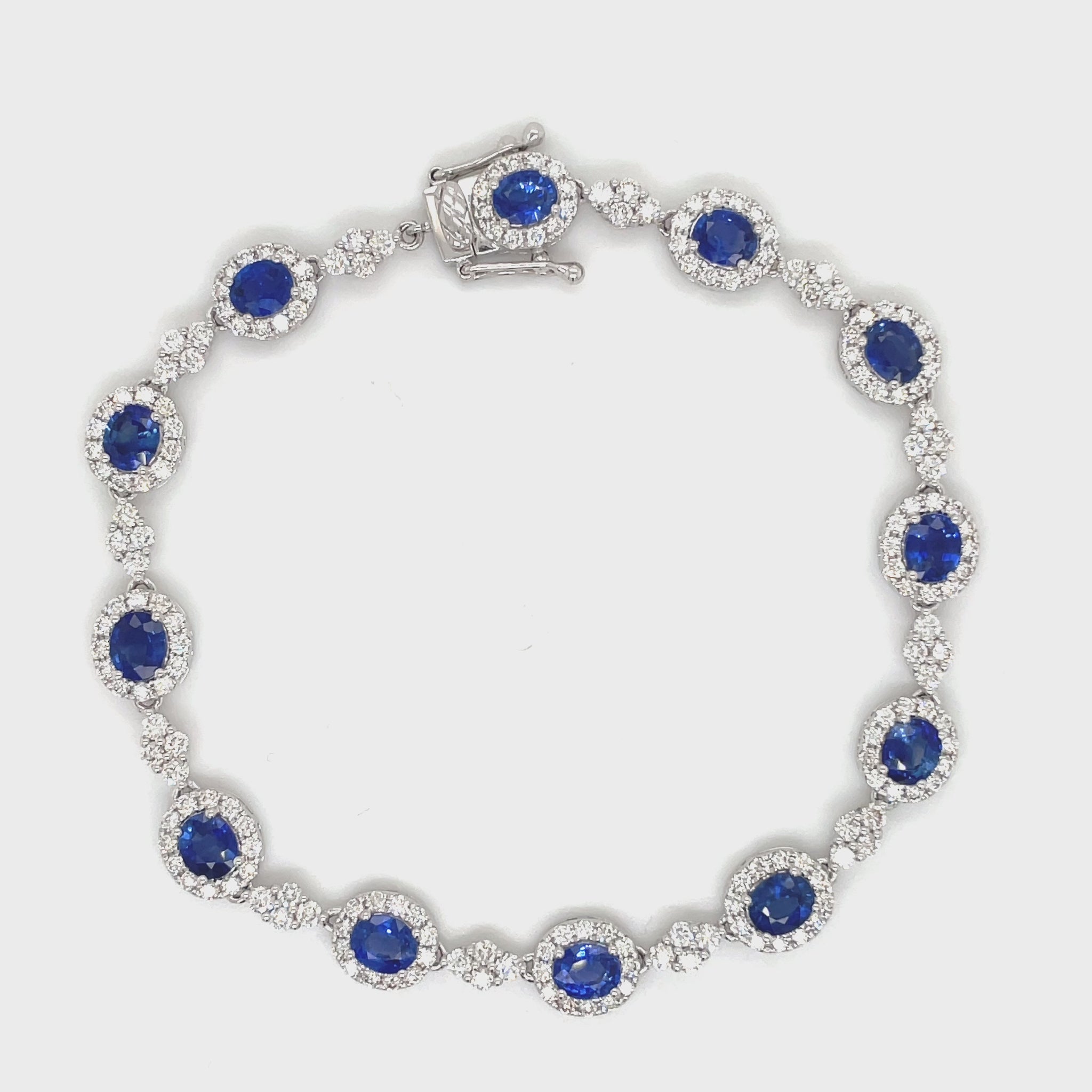 ndulge in luxury with our Blue Sapphire and Diamond Bracelet. The oval shape sapphires, totaling 5.97 carats, are complemented by 3.08 carats of round diamonds, set in 18k white gold. The hidden clasp ensures a seamless and elegant look, perfect for any occasion. Measuring 7.5", this bracelet is a must-have for any sophisticated and exclusive wardrobe.