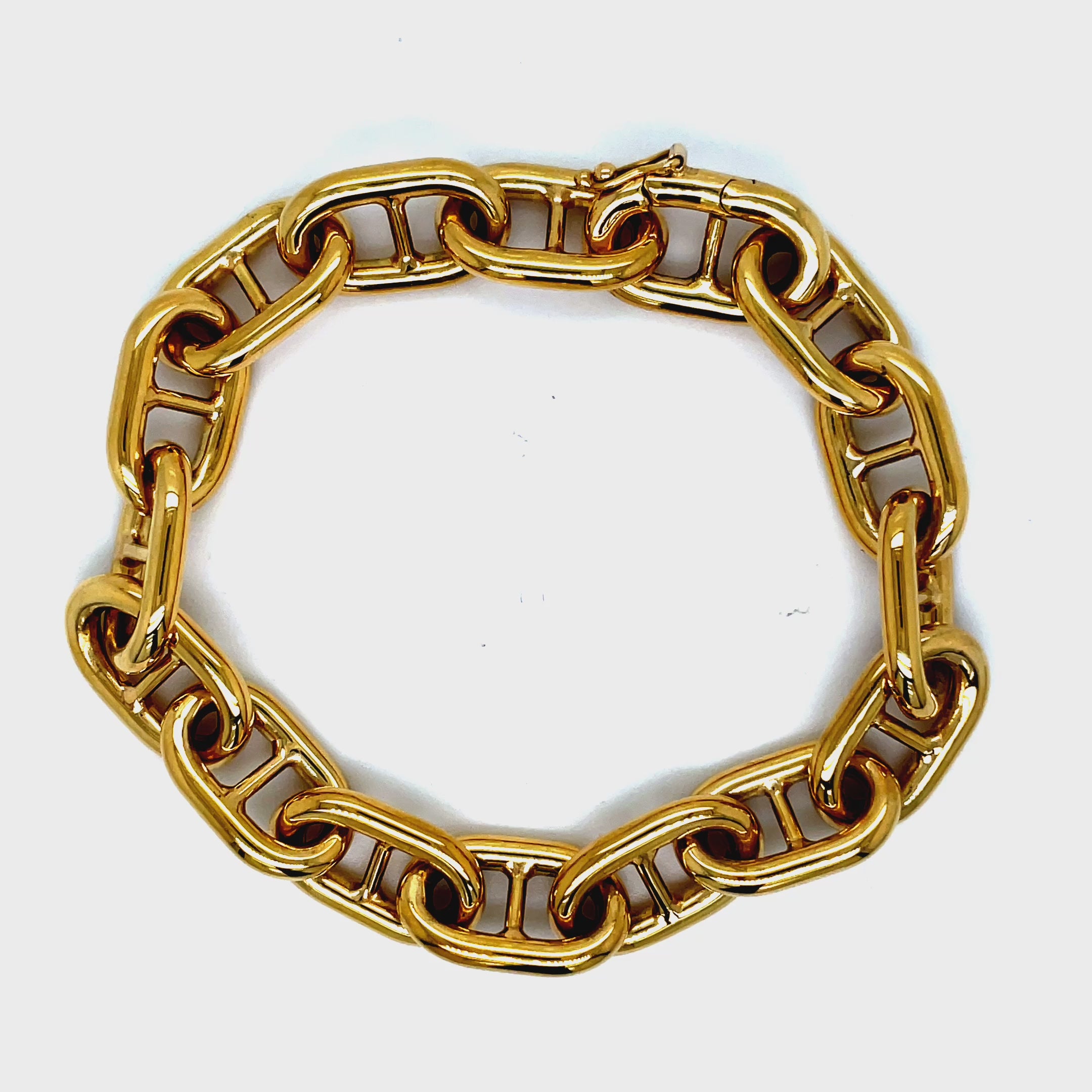 ndulge in luxury with our 18k Italian Solid and Thick Mariner Link Bracelet. Handcrafted in Italy, this bracelet boasts a striking 18k yellow gold finish and a distinctive mariner link design. The solid construction and 11.00 mm thickness add to its opulent feel. With a hidden clasp, it exudes an air of exclusivity. Elevate your style with this timeless piece.