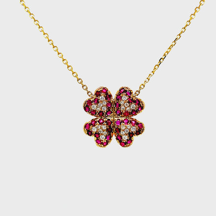 Exude elegance with our Four Petal Ruby and Diamond Pendant Necklace. Adorned with stunning round rubies totaling 0.95 cts and shimmering round diamonds totaling 0.16 cts, this 14k yellow gold necklace boasts a sophisticated four petal flower design. Elevate your style and make a statement with this exclusive piece.