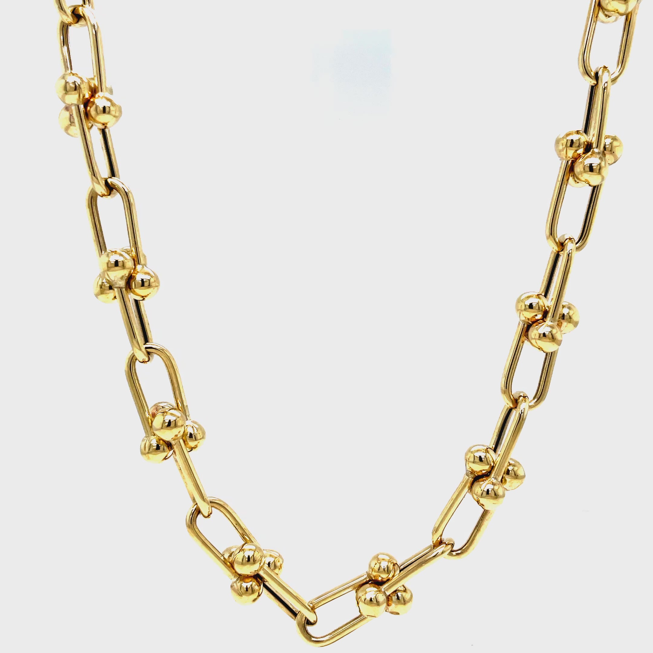 ndulge in timeless elegance with our 14K Italian Made Gold Hardware Chain Link Necklace. Crafted from luxurious 14k yellow gold, this Italian-made necklace features a secure lobster catch and a sturdy hardware link design. At 18" in length and 7.50 mm in thickness, it is the perfect statement piece for any occasion.