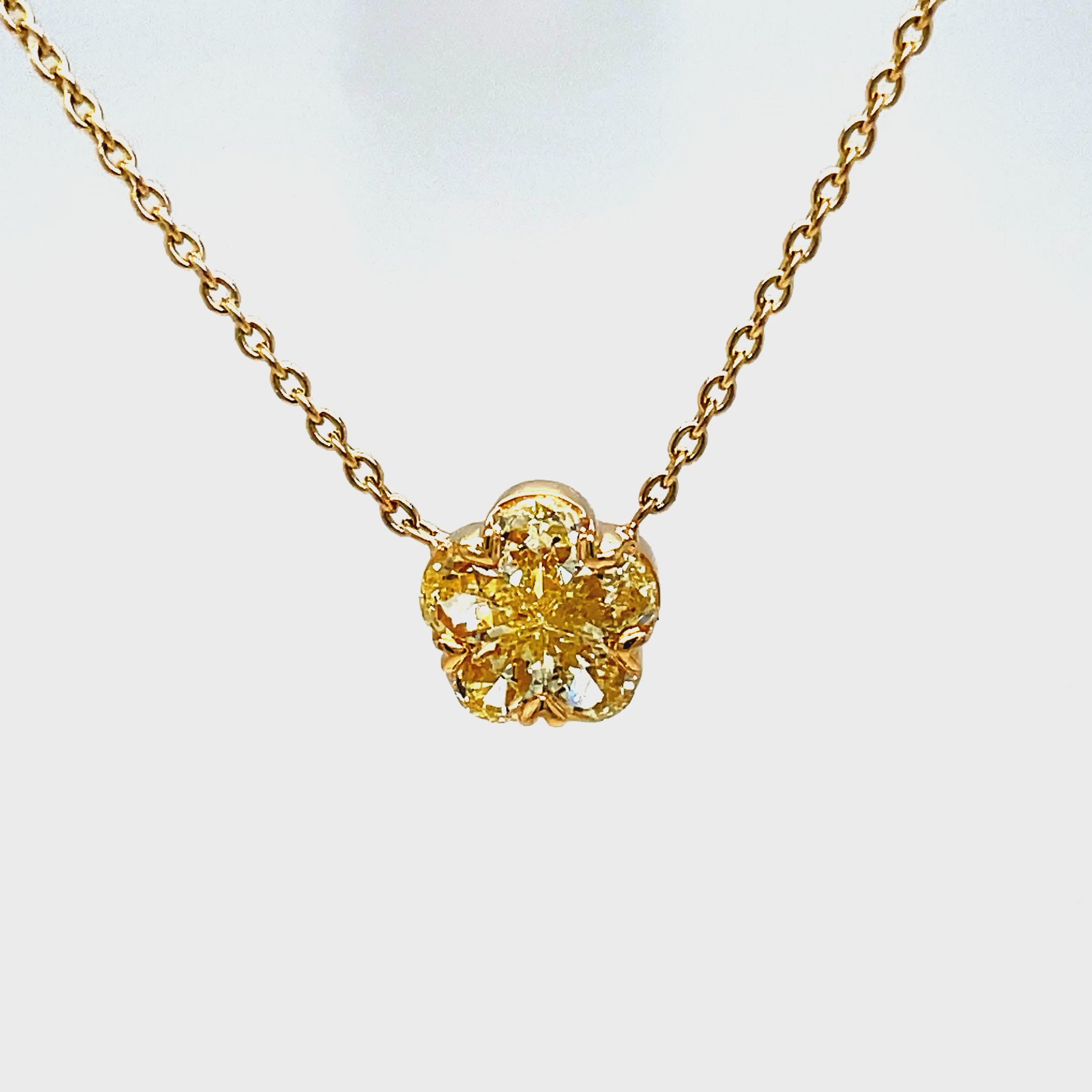 Elevate your style with our Fancy Yellow Diamond Flower Pendant Necklace. This exquisite piece features 0.66 cts of fancy yellow diamonds set in a delicate flower motif, all crafted in 18k yellow gold. Add a touch of luxury to any outfit with this stunning pendant necklace.