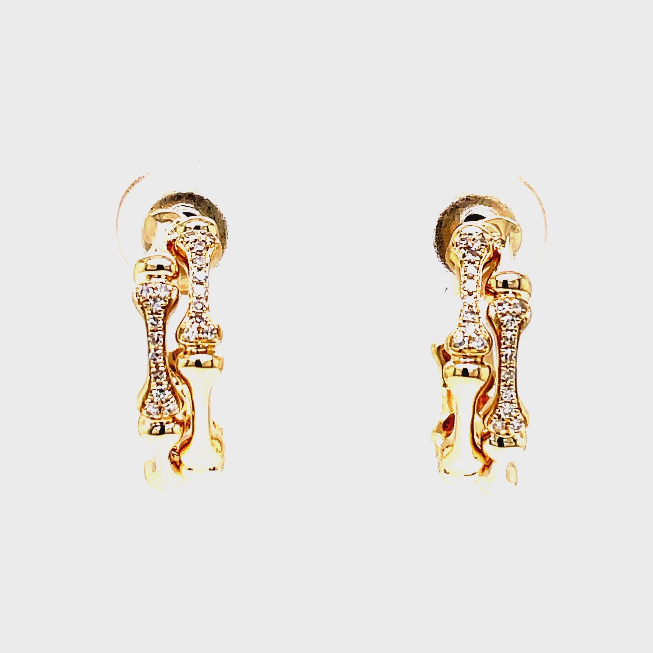 Indulge in luxury with our Diamond Bamboo Style Hoop Earrings. Crafted from 14k yellow gold, the bamboo style exudes elegance and the secure friction backs provide added peace of mind. Adorned with sparkling round diamonds, these earrings will elevate any outfit with their 0.09 cts of brilliance.