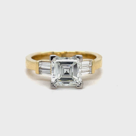 Indulge in the exquisite luxury of our Custom Made Assher Cut &amp; Baguette Engagement Ring, featuring a 14k yellow gold band adorned with a stunning 1.71 ct assher cut diamond in a prong setting. The color G and SI1 clarity ensure brilliance, while the delicate baguette diamonds on the side add a touch of sophistication. Elevate your proposal with this exclusive, one-of-a-kind ring.