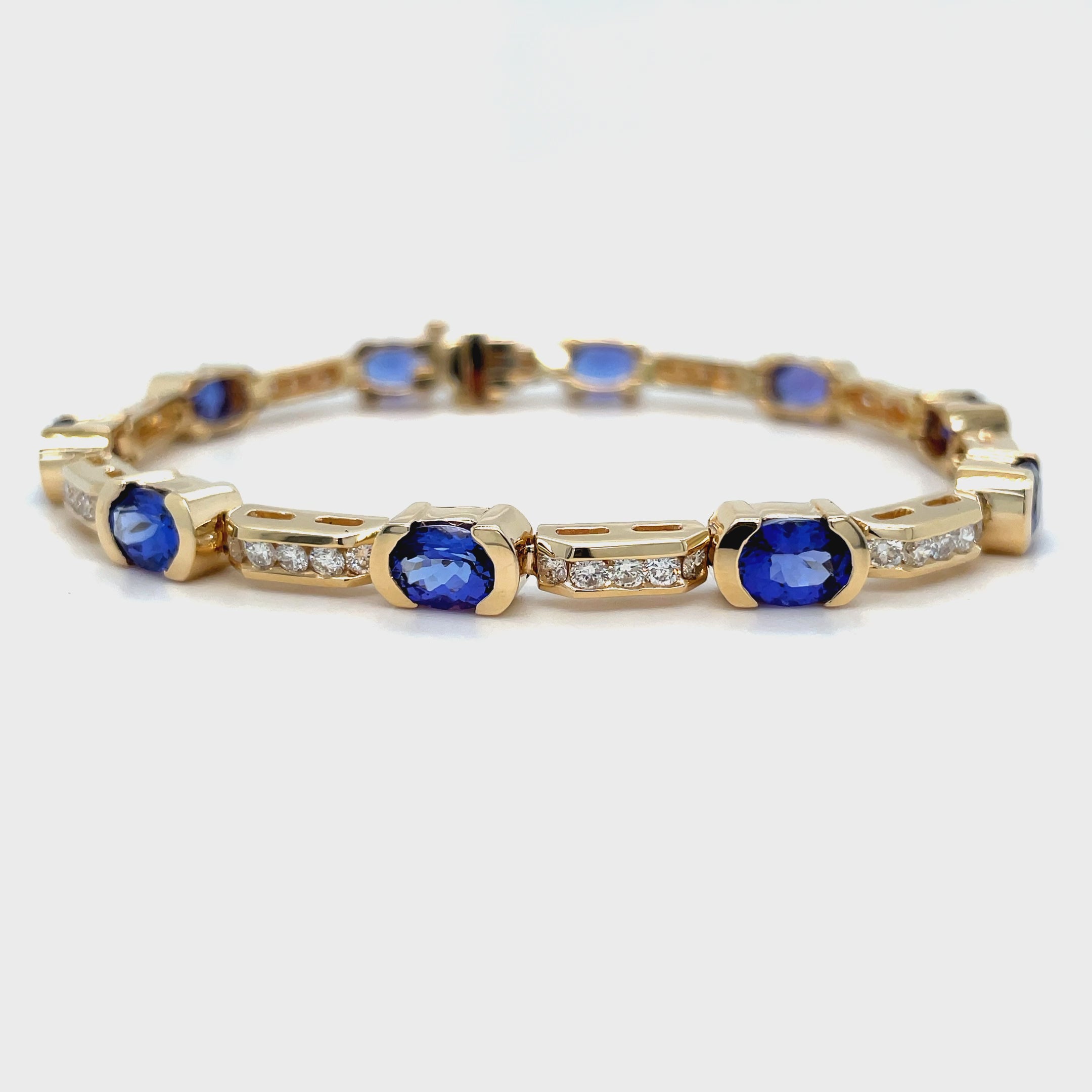 Experience the elegance and glamour of our Fine Diamond & Tanzanite Oval Shape Bracelet. Crafted from 14k yellow gold, this one-of-a-kind bracelet features smooth movement, a hidden clasp, and a stunning combination of oval shape rubies (8.50 cts) and round diamonds (2.00 cts). Impress with 7 inches of pure luxury