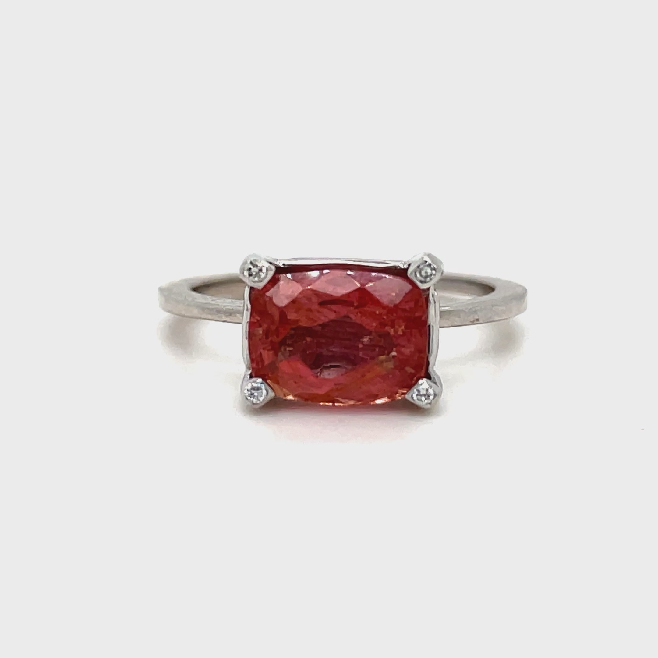 Indulge in luxury with our Horizontal Oval Cut Pink Topaz Ring. Crafted with 14k white gold, this ring features a stunning oval cut pink tourmaline, accented by four small diamonds on each corner. The horizontal setting adds a unique touch of elegance to this timeless piece. Elevate your style with this exclusive ring.