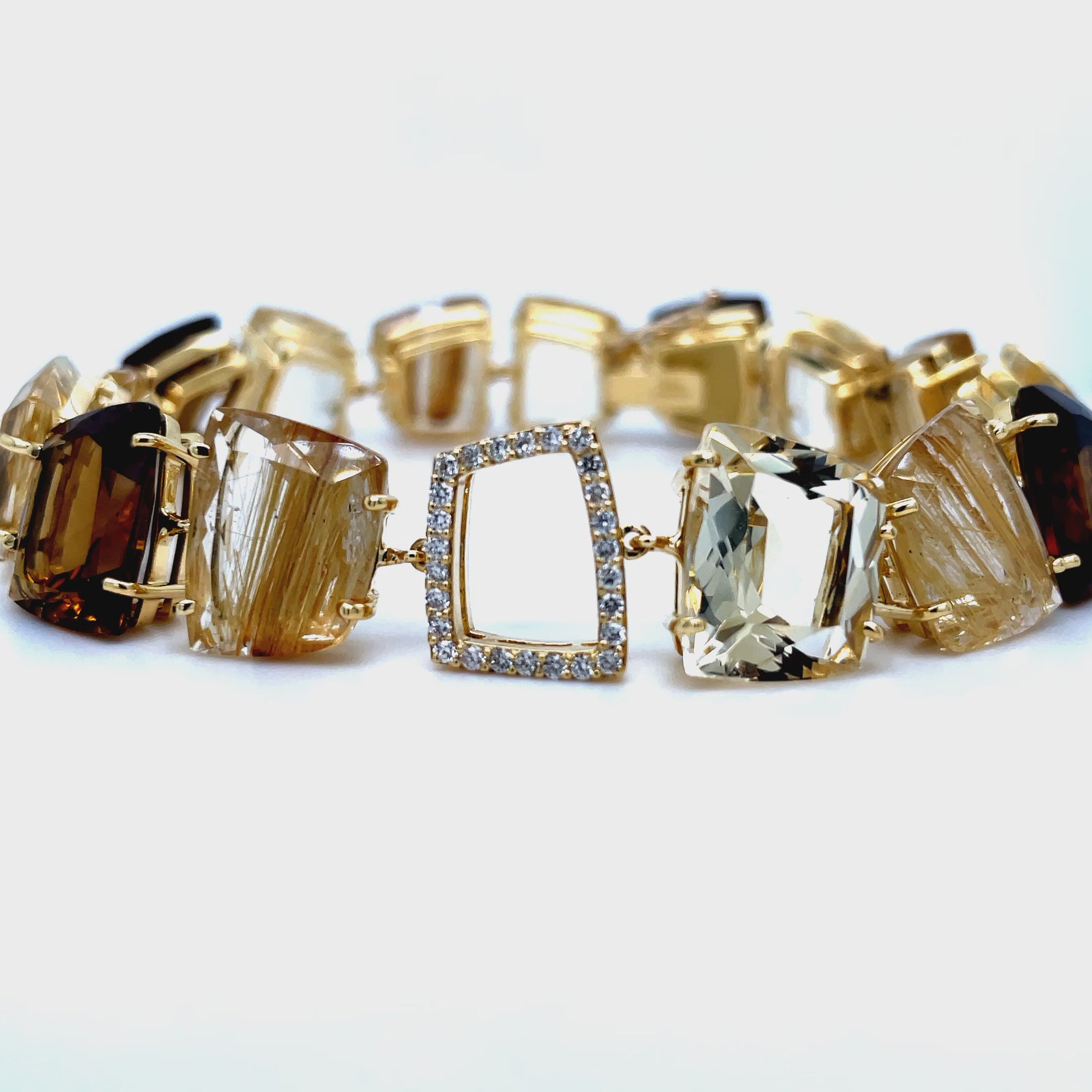 mbrace the luxurious allure of this exquisite bracelet, handcrafted in Brazil with special cut citrine, whisky citrine, and ritulated quartz stones. Adorned with round diamonds totaling 0.28 cts, the secure hidden clasp adds a touch of sophistication to this one-of-a-kind piece. Elevate your style with this exclusive gemstone bracelet.