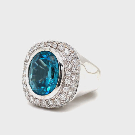 Indulge in luxury with our exquisite Italian made Blue Zircon and Diamond Cocktail Ring. Crafted with 18k white gold, the oval shape zircon (10.68 cts) shimmers with elegance, while the round diamonds (1.35 cts) add a touch of glamour. The wide gold ring completes this sophisticated and exclusive piece, making it a must-have for any fashion-forward woman.