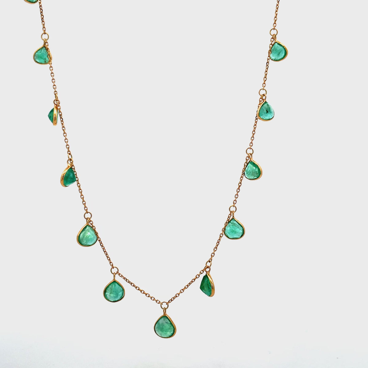 Try on view of 18k Pear-Shaped Emerald Charm Necklace in Yellow Gold