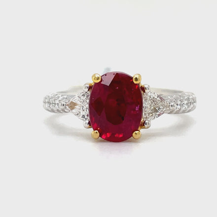 Indulge in luxury with our Oval Madagascar Ruby and Trillion Diamond Ring. This exquisite piece features a stunning oval ruby from Madagascar, weighing 1.71 carats, surrounded by 0.58 carats of round diamonds set in 18k white gold. The perfect combination of sophistication and opulence, with yellow gold prongs and head adding a touch of elegance.