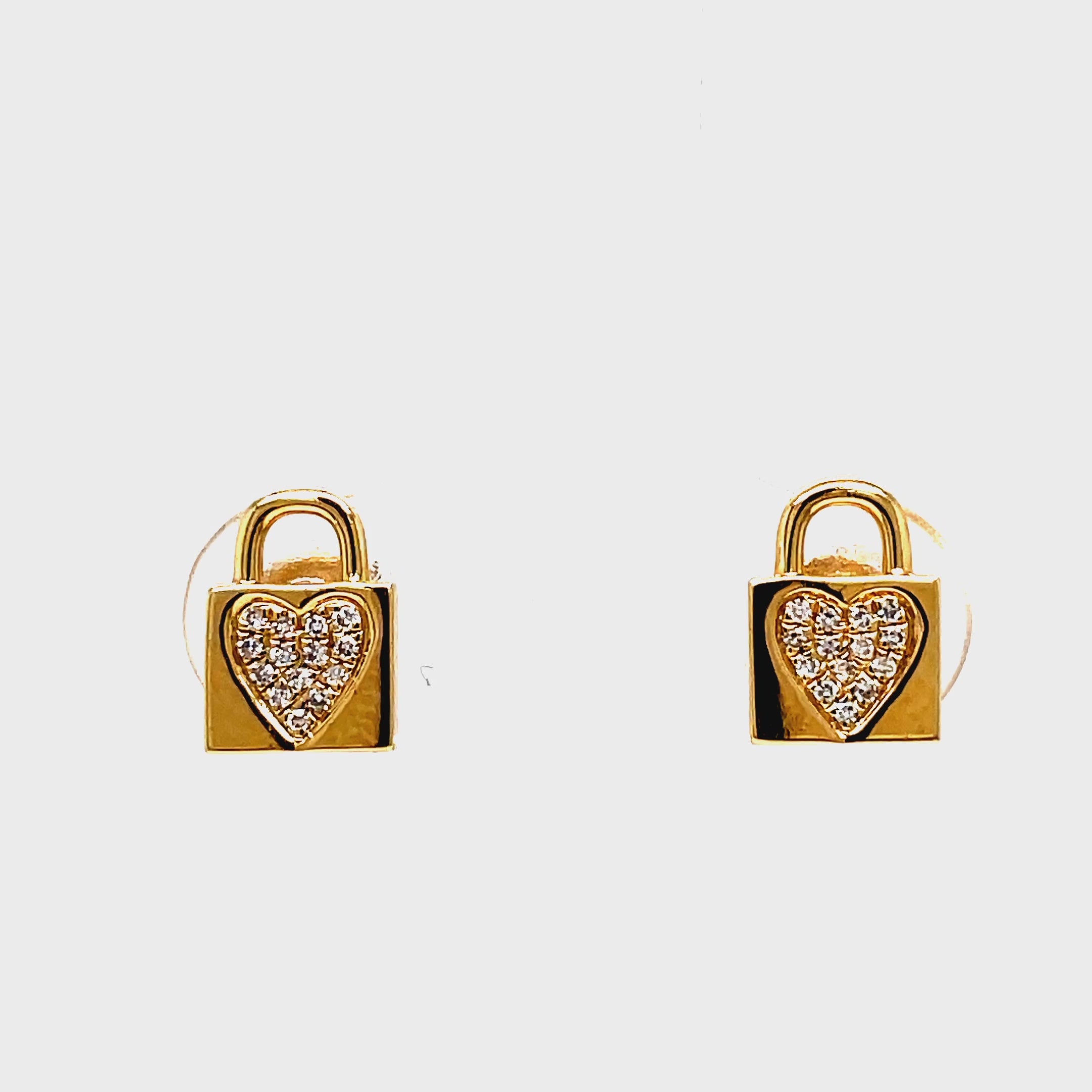 Add a touch of luxury to any outfit with our 14k Yellow Gold Small Diamond Lock Earrings. Crafted from 14k yellow gold and adorned with round diamonds totaling 0.05 carats, these earrings are the perfect statement of sophistication. The secure friction closure ensures they always stay in place for a worry-free wear. Elevate your style with these exclusive and elegant earrings.