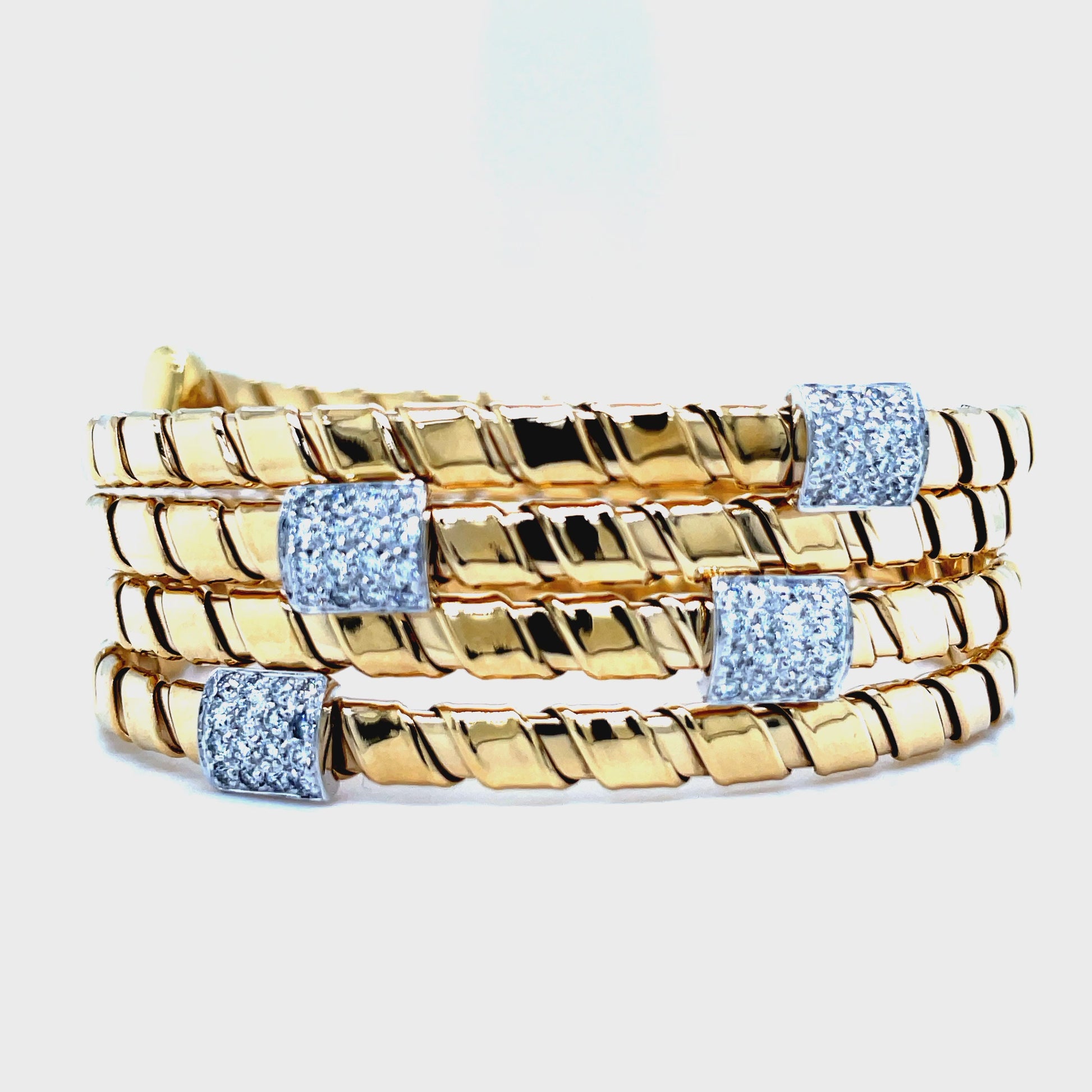 Indulge in elegance with our Italian Diamond Yellow Gold Wrap Around Spiral Flexible Bangle Bracelet. Designed by the renowned Novecentonovantanove, this bracelet boasts a classic and contemporary design, crafted with 18k yellow gold using the innovative tubogas technique for ultimate flexibility. Featuring four sets of sparkling round diamonds 0.64 cts, wrap around that shows 4 rows of bracelets&nbsp;