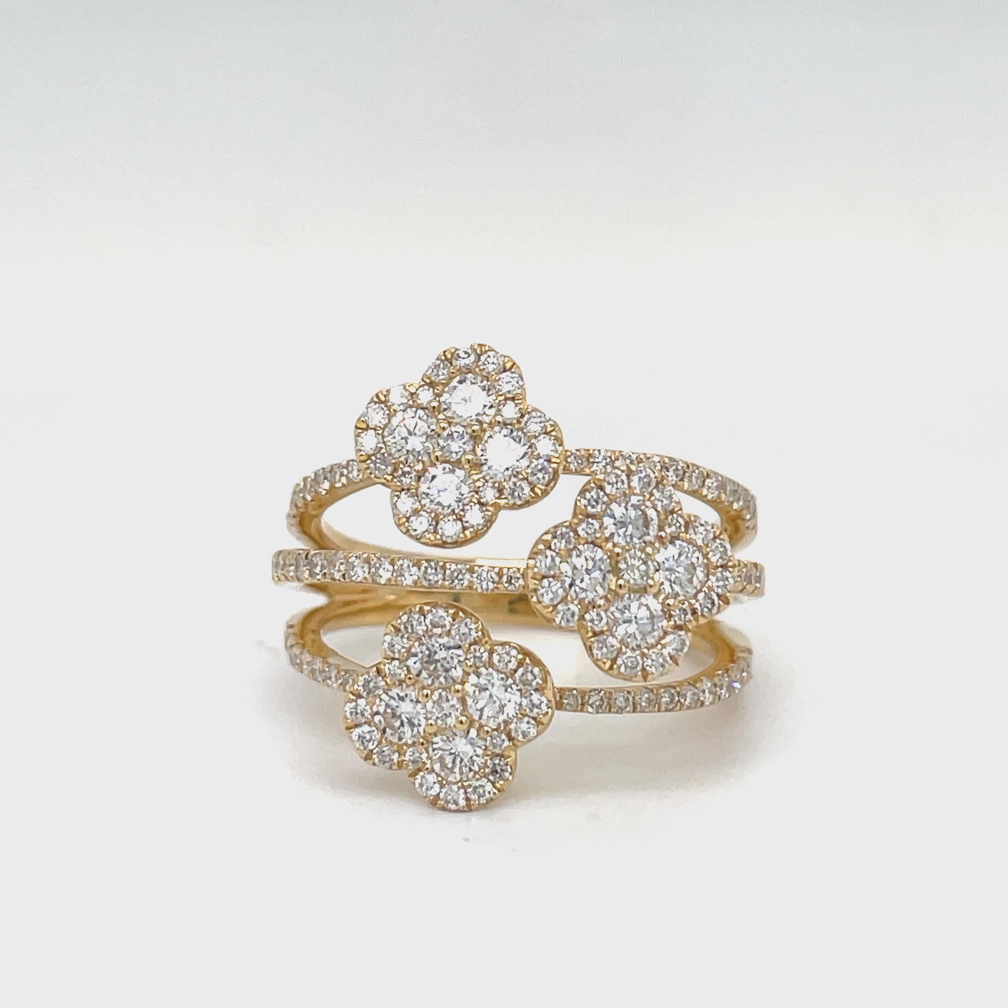 Indulge in the luxurious elegance of our Triple Flower Diamond Ring. Featuring a stunning 1.44 carat round diamond set in 18k yellow gold, this triple cross over ring will add a touch of sophistication and charm to any ensemble. Enhance your style and make a statement with this exquisite piece.