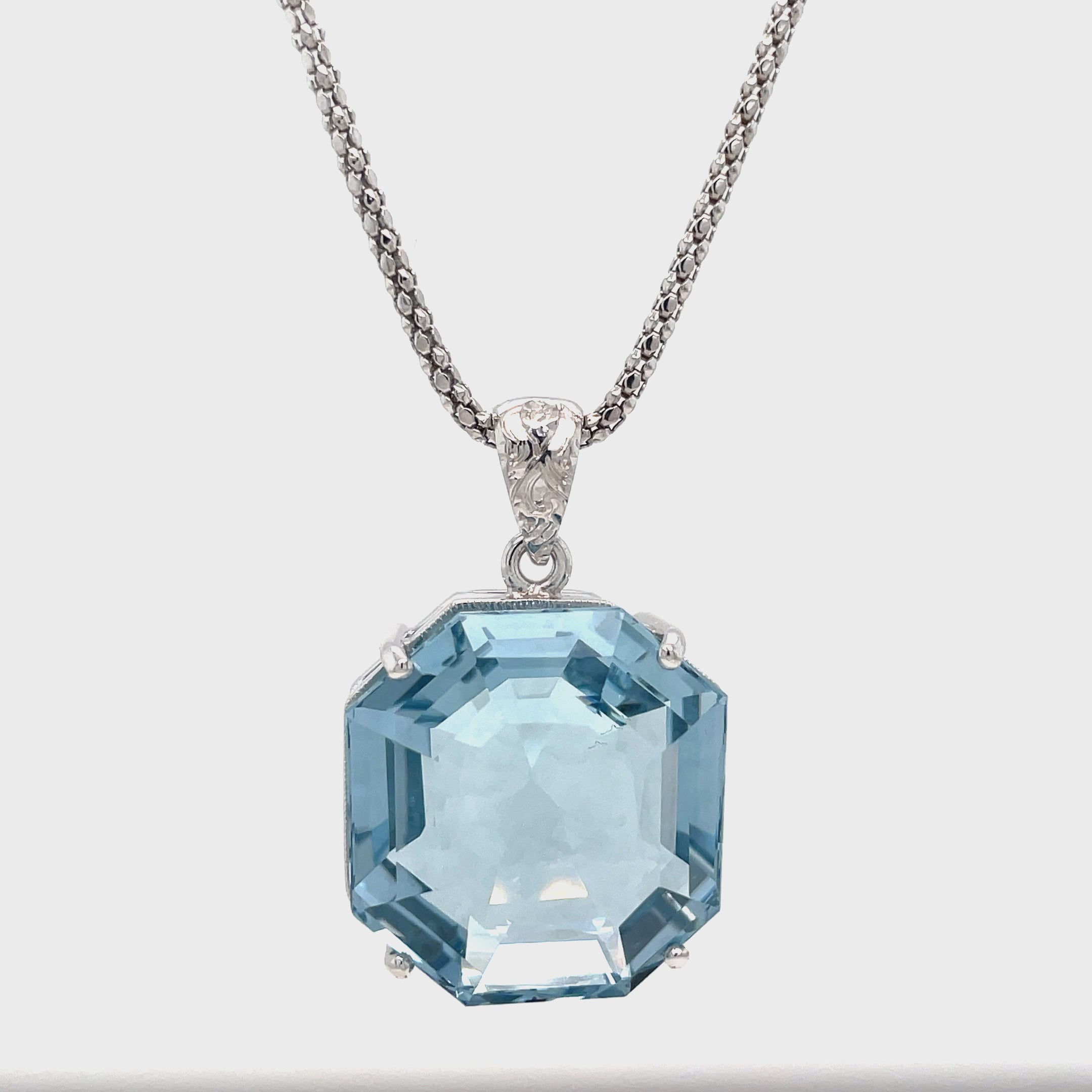 Expertly designed and crafted, our Aquamarine Necklace features a stunning octahedron aquamarine with a diamond cut bail. The custom-made white gold mounting adds a touch of elegance and is complemented by an Italian-made chain. Elevate any outfit with this eye-catching necklace. Chain is optional 20" long ($550)