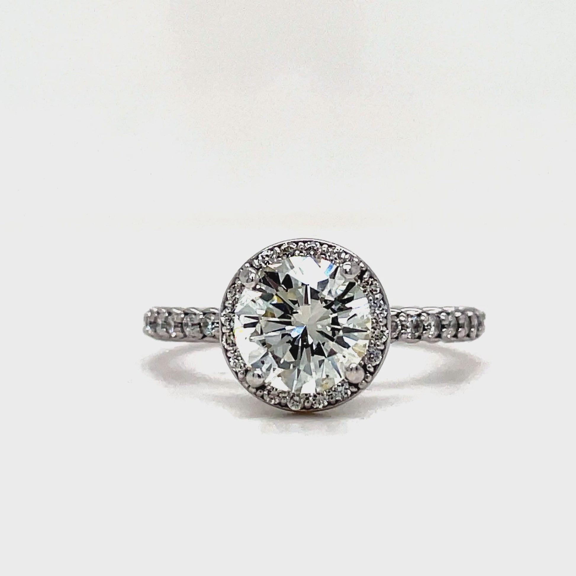 ndulge in the ultimate luxury with our Custom Made Diamond Bezel Round Brilliant Diamond Ring. The stunning round brilliant cut diamond weighing 1.16 cts, color I, clarity VS2, is set in a sparkling diamond bezel. The round diamonds in the band add even more beauty to this exquisite piece, crafted in 14 k white gold. Elevate your style and make a statement with this exclusive and sophisticated diamond ring.