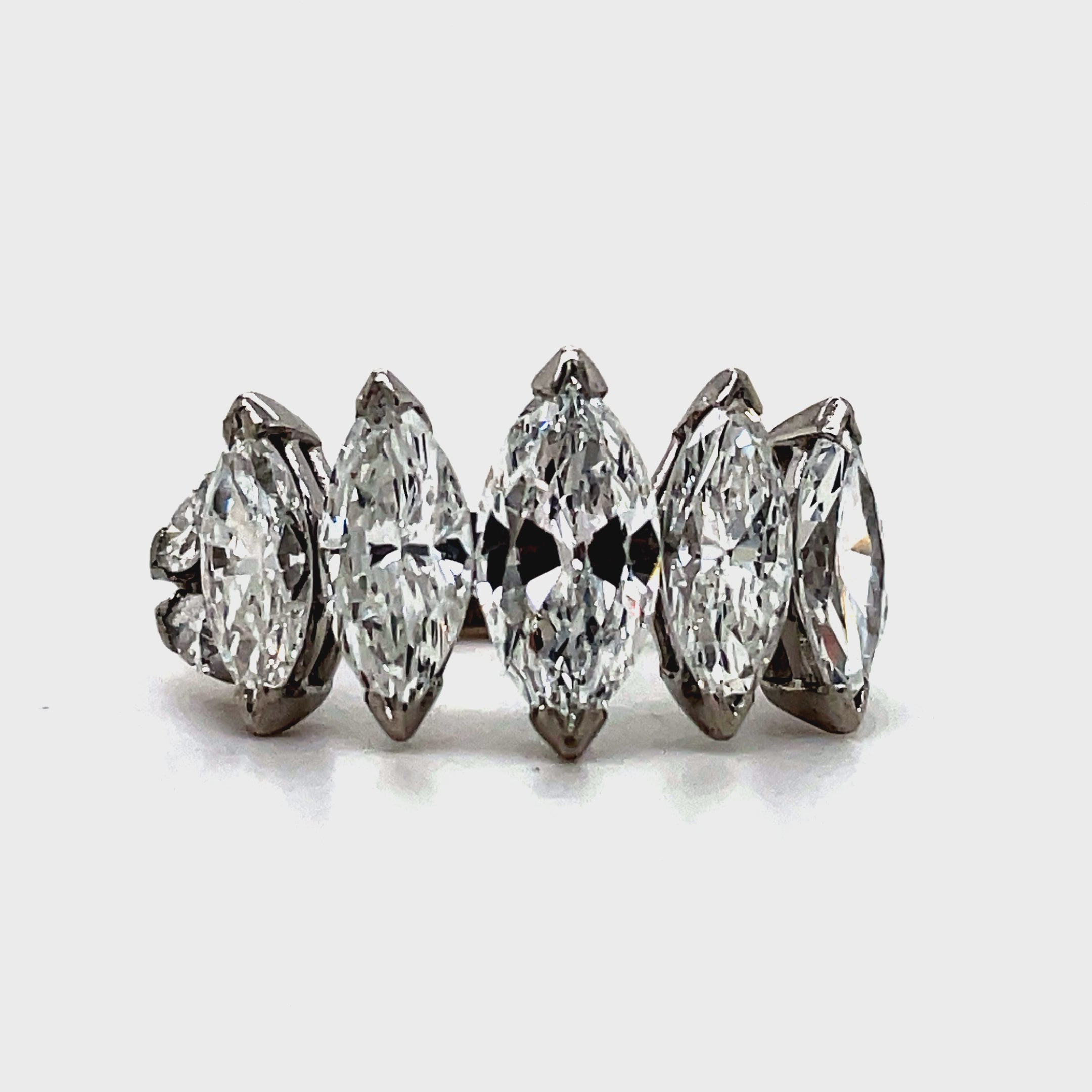 Indulge in luxury with our Platinum Marquise Cut Anniversary Ring. Five large, graduated marquise cut diamonds totaling 5.10 carats elegantly adorn this platinum ring. With a color grade of G/H and clarity of VVS1, this ring is a true masterpiece, perfect for celebrating your special milestones.