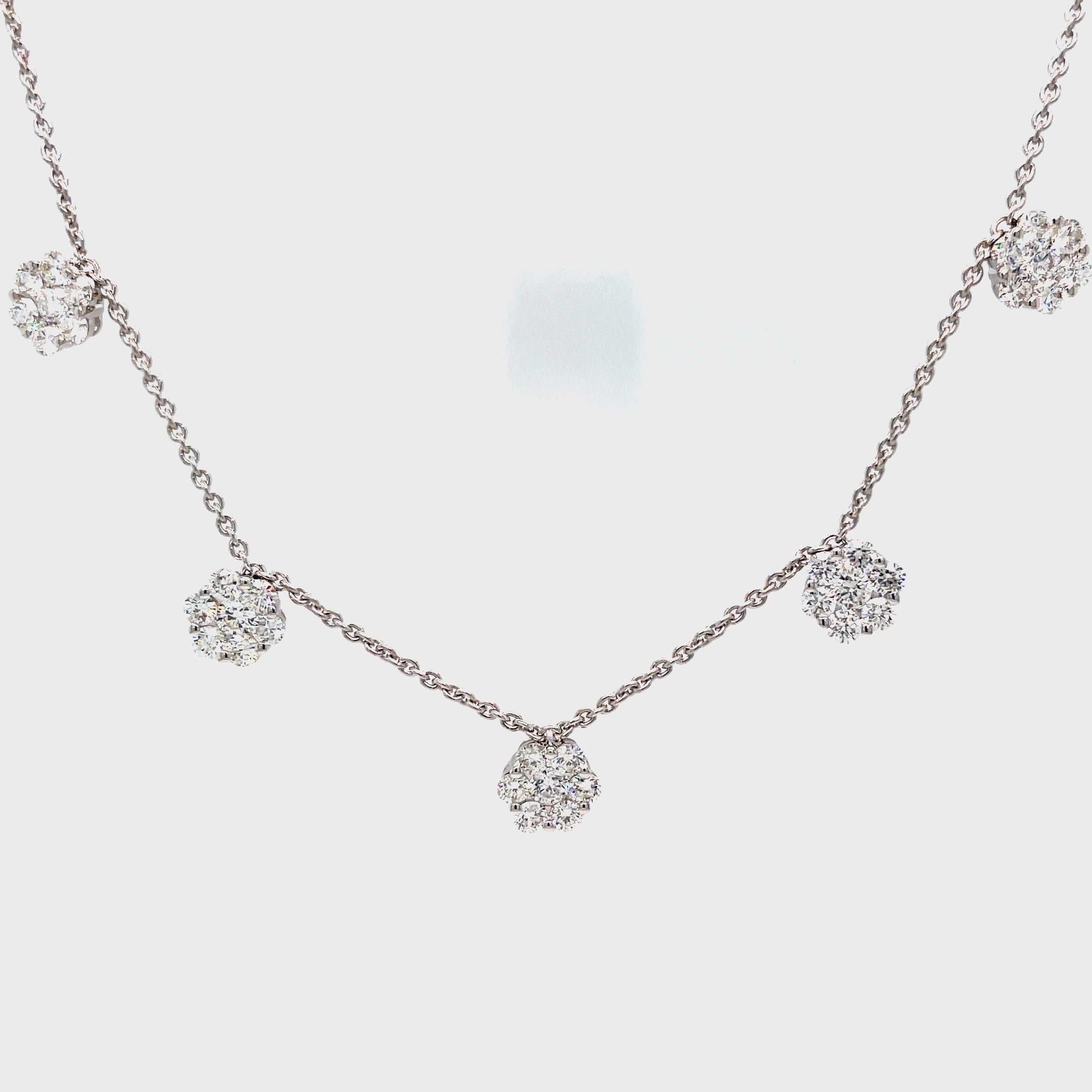 Elevate any outfit with this 18k white gold necklace featuring five stunning flower design charms adorned with sparkling 2.12 cts of white round diamonds. The F/G color of the diamonds add a touch of elegance, while the secured lobster catch ensures a worry-free wear. The 18" length is perfect for layering and completing your look.