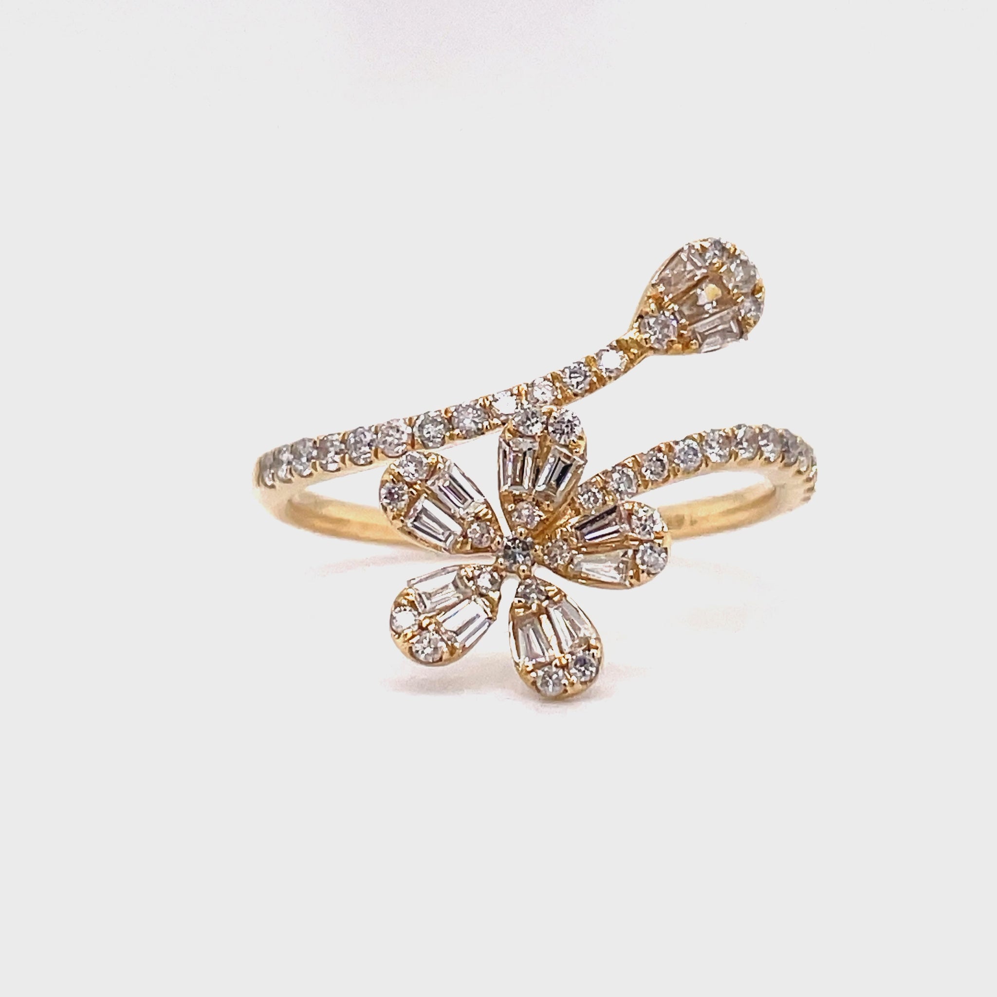 ndulge in luxury with our Mixed Cut Diamond Flower Ring. Crafted from 14k yellow gold, this wrap around ring features a stunning five petal flower adorned with round and baguette diamonds totaling 0.48 carats. Elevate your style with this sophisticated and exclusive piece.