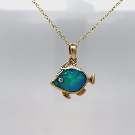 This exquisite 14k Diamond Opal Fish Pendant Necklace is a true work of art. Crafted with lustrous, 14k yellow gold, the play of color opal shimmers with an ethereal glow. The delicate fish pendant, adorned with a sparkling round diamond, adds a touch of whimsy to this luxurious piece. Elevate your wardrobe and make a statement with this one-of-a-kind necklace.