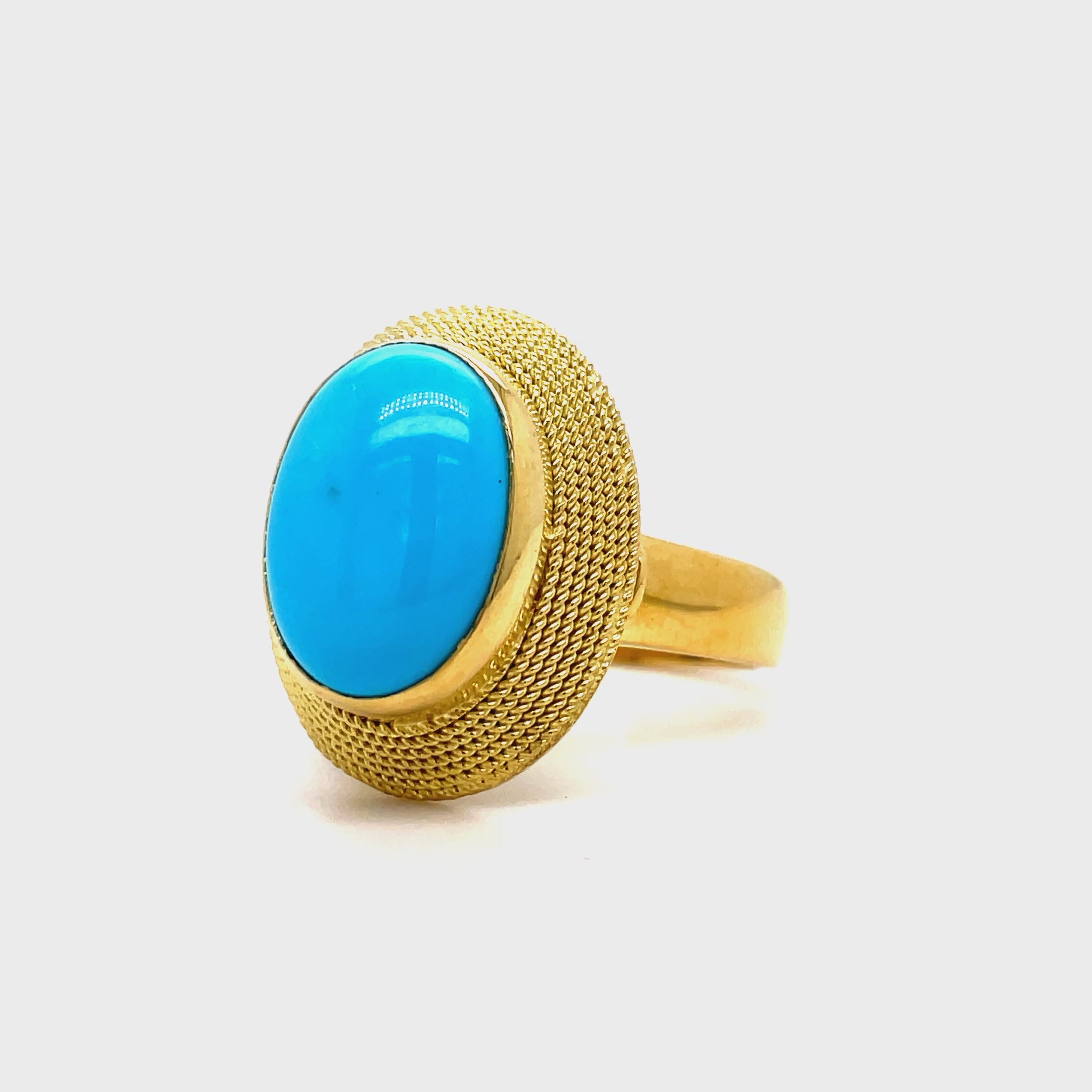 Indulge in the allure of our 18k Italian Made Turquoise Cabochon Ring. Handcrafted with a matte finish and ornate rope detailing, this ring exudes luxury. Adorned with a captivating turquoise cabochon and gallery finish at the back, it's the perfect marriage of elegance and art.