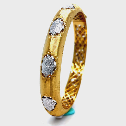 Elevate your style with our Italian 18K Yellow Gold Diamond Bangle Bracelet. Handcrafted with 18K gold, this exquisite piece features round diamonds for a total of 0.50 cts. The brushed finish adds a touch of elegance and sophistication. Indulge in luxury and make a statement with this Italian-made bracelet.