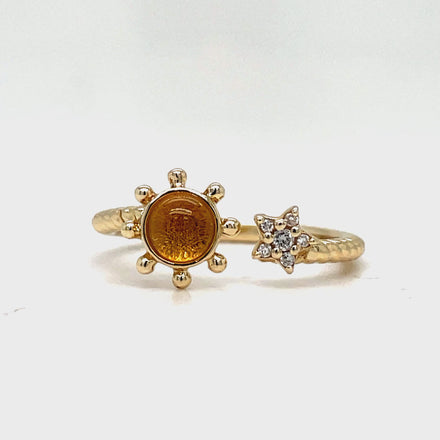 Indulge in luxury with our Yellow Gold Citrine Sun and Diamond Star Open Ring. Crafted with 14k yellow gold, a stunning citrine cabochon, and sparkling round diamonds, this open ring exudes elegance and sophistication. Perfect for adding a touch of glamour to any outfit.