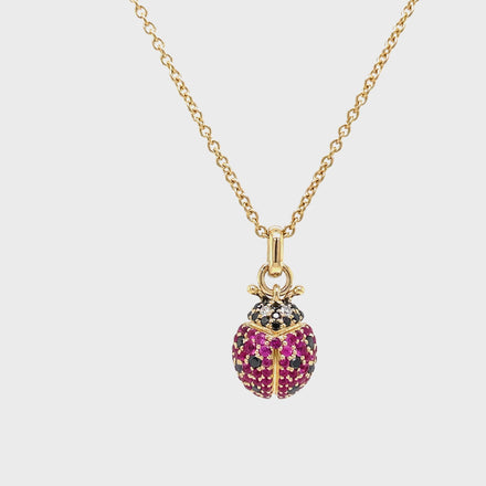 Indulge in luxury with our 14k Diamond Lady Bug Necklace. Crafted with 14k yellow gold, this exquisite piece features a 18.00 mm stunning lady bug design adorned with round black and pink sapphires totaling 0.49 carats. With an adjustable 18" chain and secure lobster clasp, this necklace adds a touch of sophistication to any outfit.