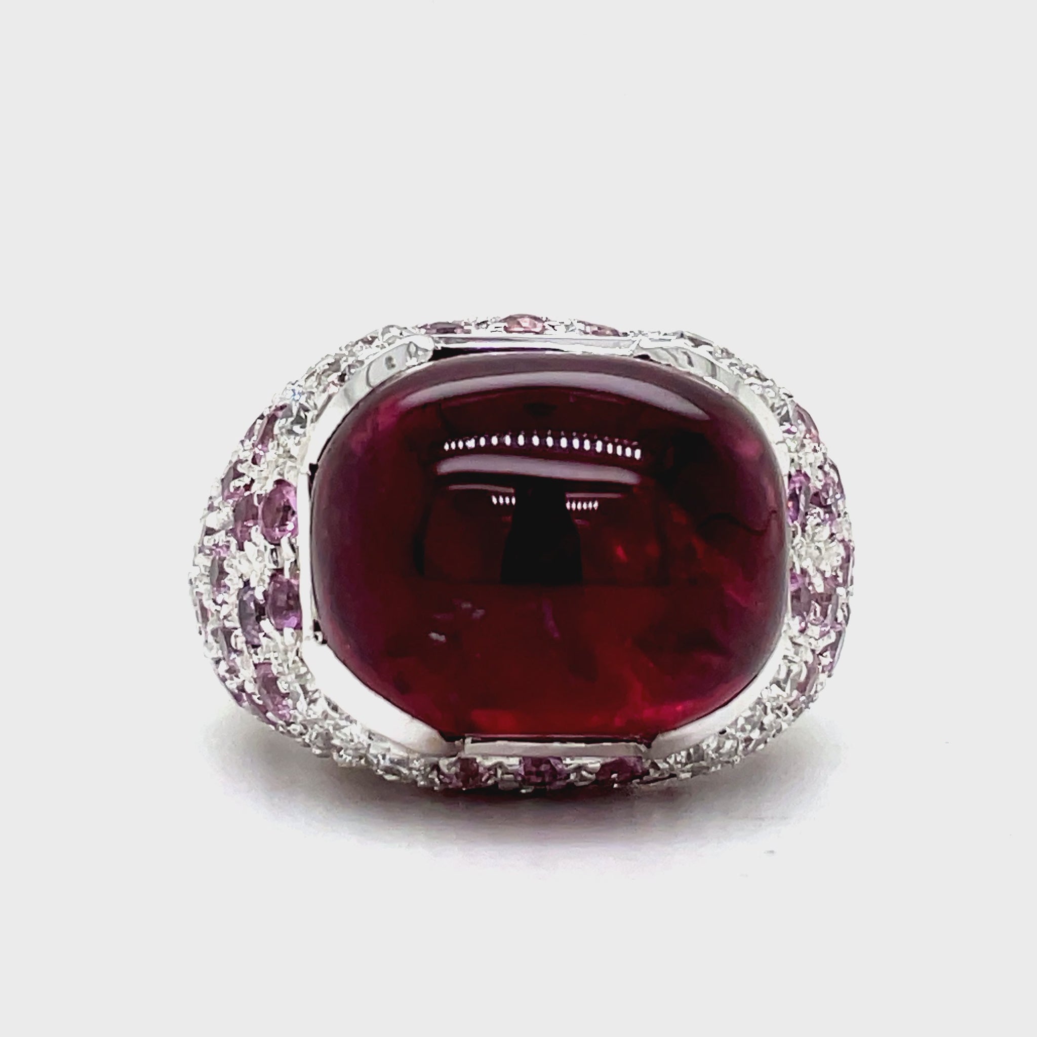 Elevate your style with this luxurious Italian-made ring. Crafted with 18k white gold, it features a stunning ruby cabochon (4.88 cts) and a vibrant pink topaz (7.60 cts). Adorned with round diamonds (0.64 cts) in a pave setting, this ring exudes elegance and sophistication.