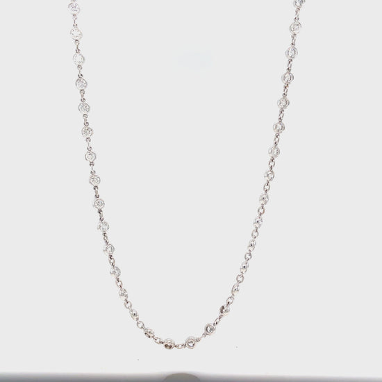 Transform any outfit into a glamorous statement with our Diamonds By the Yard Chain Necklace. Adorned with 60 round diamonds totaling 4.14 carats, this 18k white gold necklace is 18" long, providing the perfect balance of sparkle and elegance. Elevate your style with this luxurious piece.
