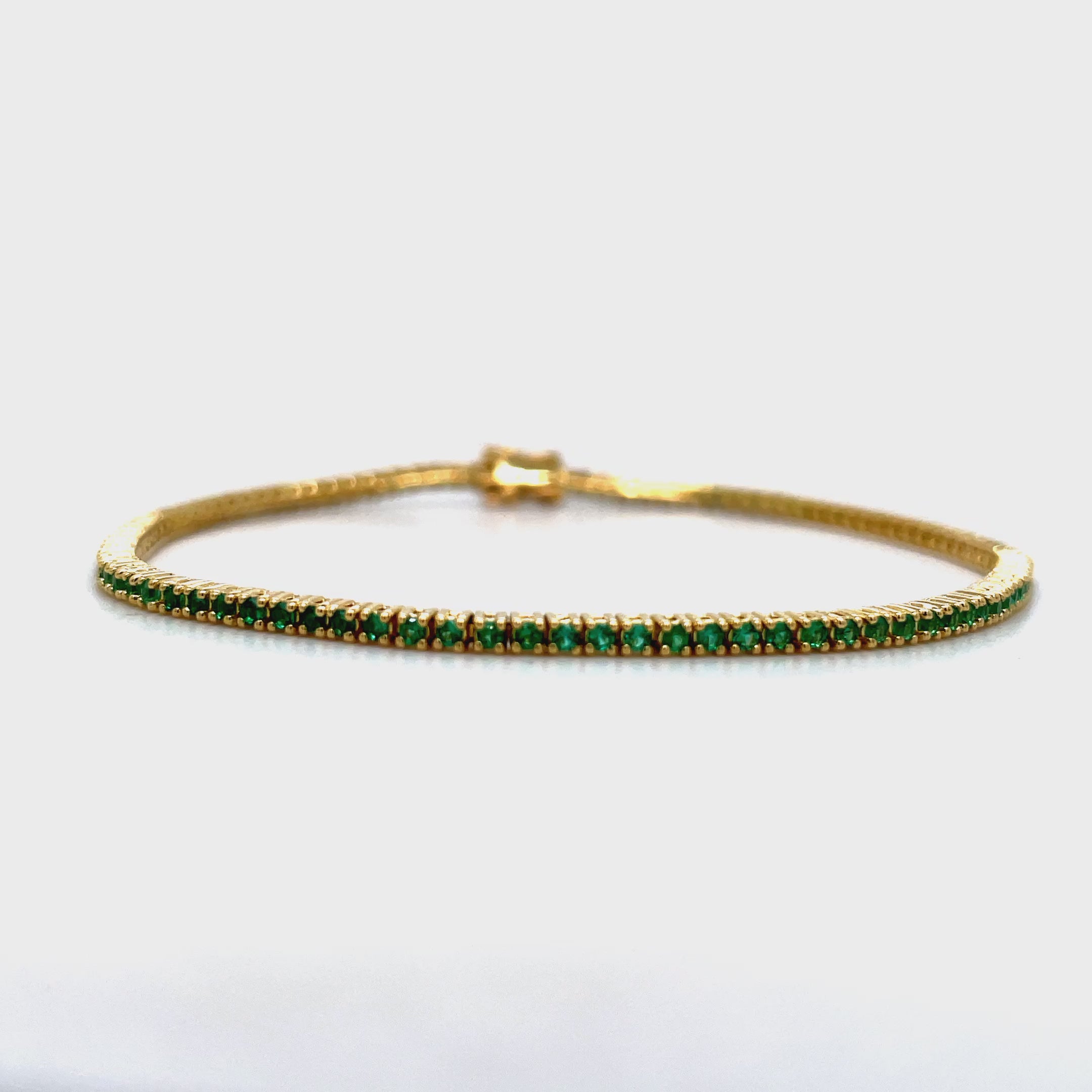 ndulge in luxury with our 18k Italian Made Emerald Line Tennis Yellow Gold Bracelet. Handcrafted in Italy, this exquisite piece features 1.00 cts of round emeralds with good color. The secure clasp ensures peace of mind, making it a must-have for your jewelry collection. Elevate your style with this exclusive line bracelet.