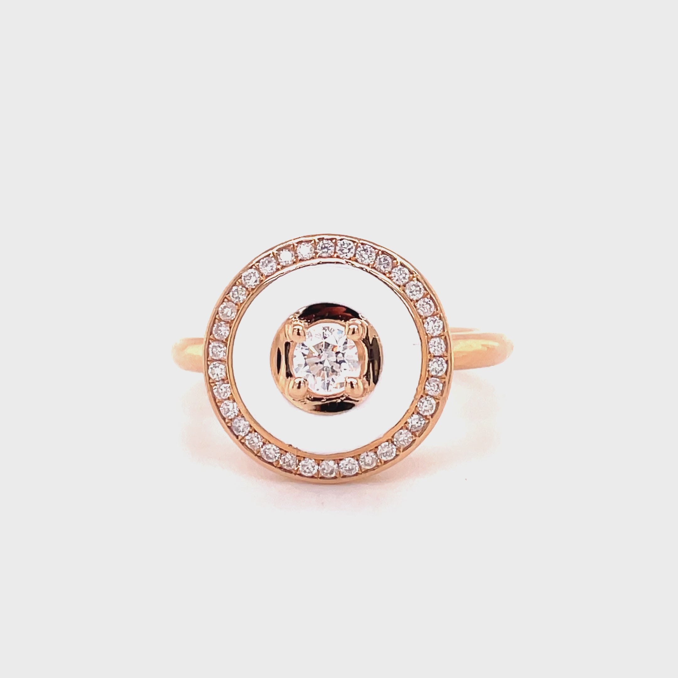 This exquisite ring is made of 14k rose gold with round diamonds totaling 0.40cts. It features a diamond bezel with a round diamond in the center and an elegant white enamel background. Perfect for any occasion, this ring is a beautiful way to show someone special that you care.
