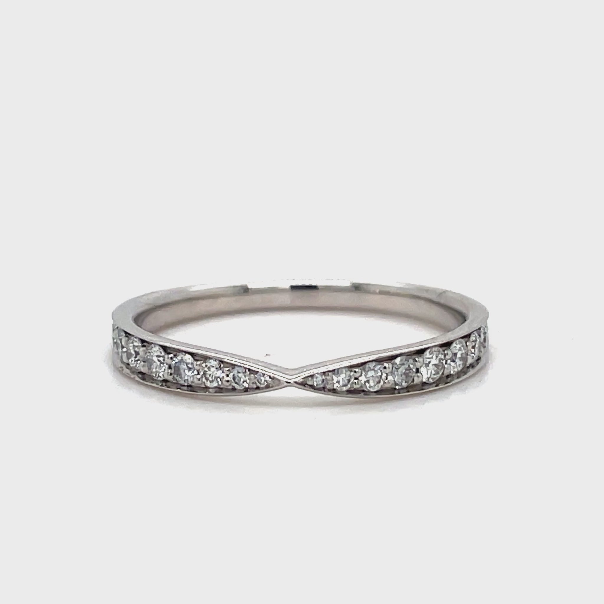 This stunning Estate Tiffany and Co. Diamond Wedding Band features a unique v-shape design adorned with brilliant round diamonds. Crafted from luxurious platinum, this band is an elegant and exclusive choice for your special day. Add a touch of sophistication and luxury to your wedding ensemble with this one-of-a-kind piece from Tiffany and Co.