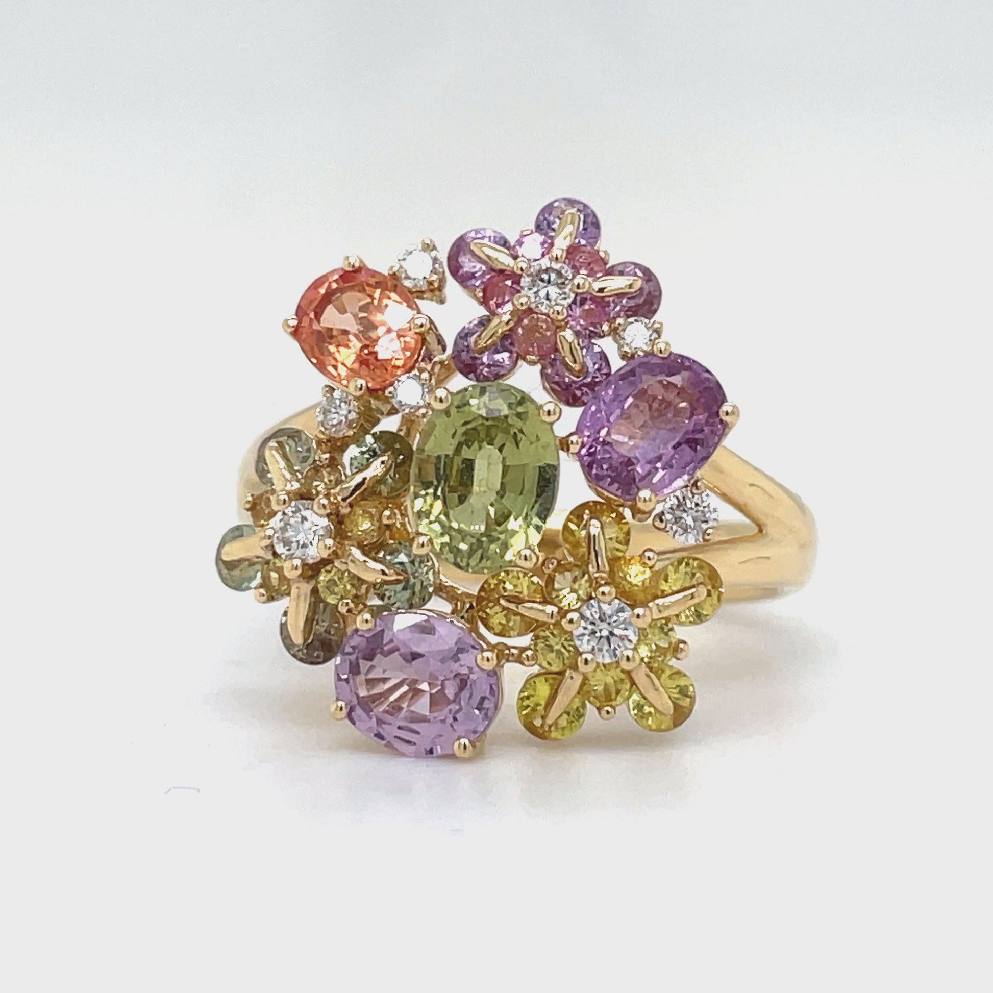 Indulge in the delicate beauty of our Multicolor Sapphire &amp; Diamond Flower Motif Ring. Adorned with 3.70 carats of multicolored sapphire stones and 0.23 carats of round diamonds, this flower-inspired ring exudes elegance and sophistication. Crafted with 18k white gold, it is a true masterpiece of refined luxury.