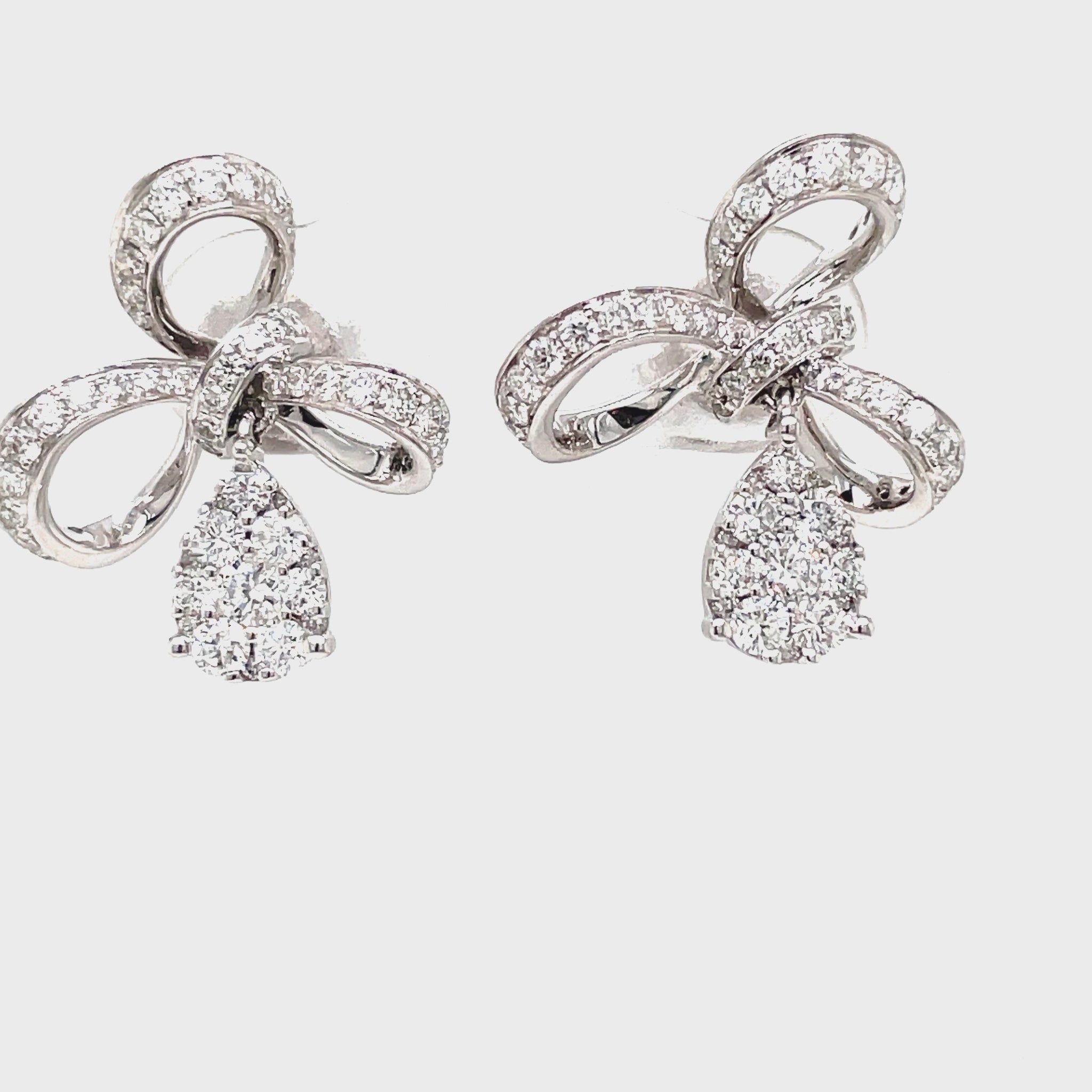 Indulge in pure elegance with our 18K Stunning Diamond Bow Drop Earrings. Crafted from 18k white gold, these earrings feature a delicate bow design adorned with sparkling round diamonds totaling 1.01 ct. Perfect for adding a touch of sophistication and luxury to any outfit.