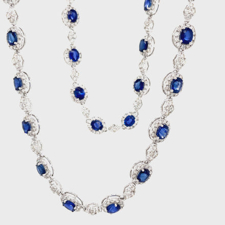 Indulge in luxury with our Blue Sapphire and Diamond Necklace. The 28 oval shape sapphires, totaling 14.67 carats, are complemented by 7.70 carats of round diamonds, set in 18k white gold. The hidden clasp ensures a seamless and elegant look, perfect for any occasion. Measuring 18", this necklace is a must-have for any sophisticated and exclusive wardrobe.