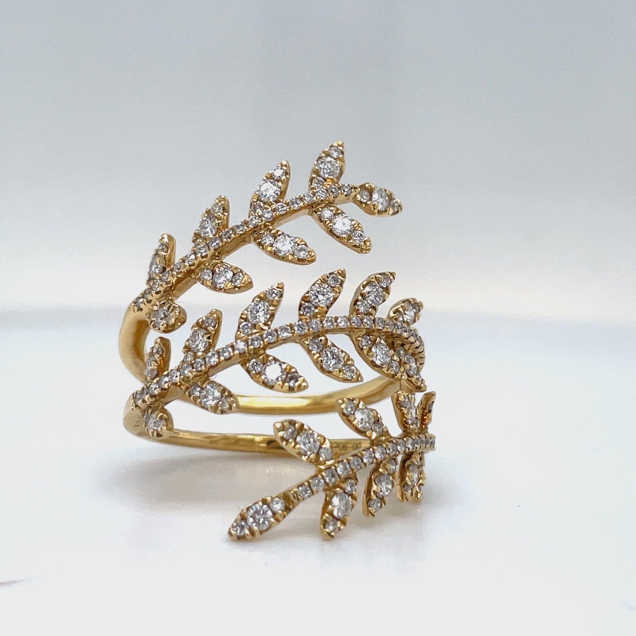 levate your style with this modern wrap around diamond leaf motif ring. Set in 18k yellow gold, the stunning round diamonds totaling 0.87 cts sparkle with color F/G and clarity VS1. The three row design adds an elegant touch to this luxurious and exclusive piece.