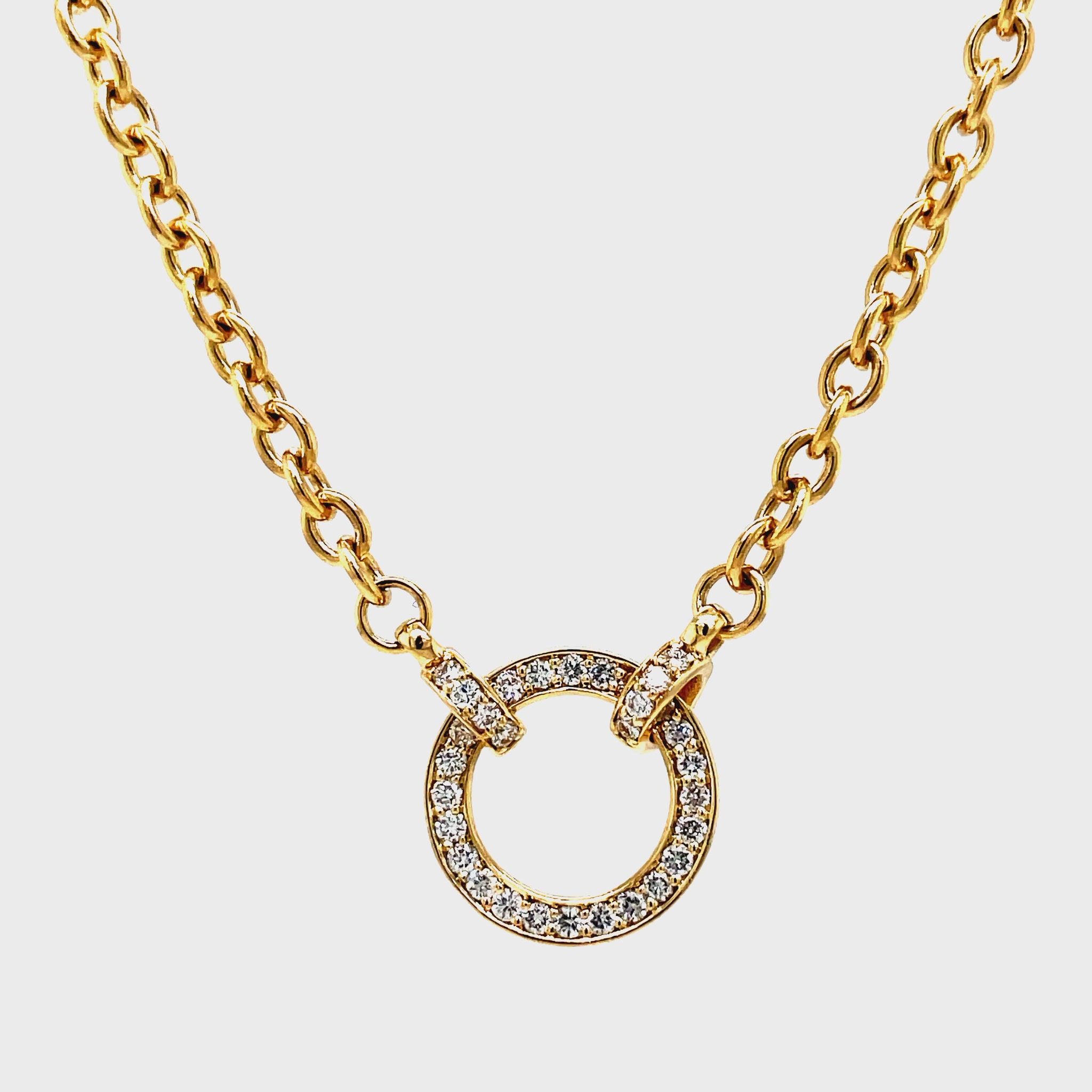 Wrap yourself in luxury with our exquisite Diamond Circle Yellow Gold Necklace. The delicate cable chain, 18" long, features a secure lobster clasp and a dazzling diamond circle, adorned with round diamonds totaling 0.31 carats. Elevate any outfit and make a statement with this timeless piece of fine jewelry.