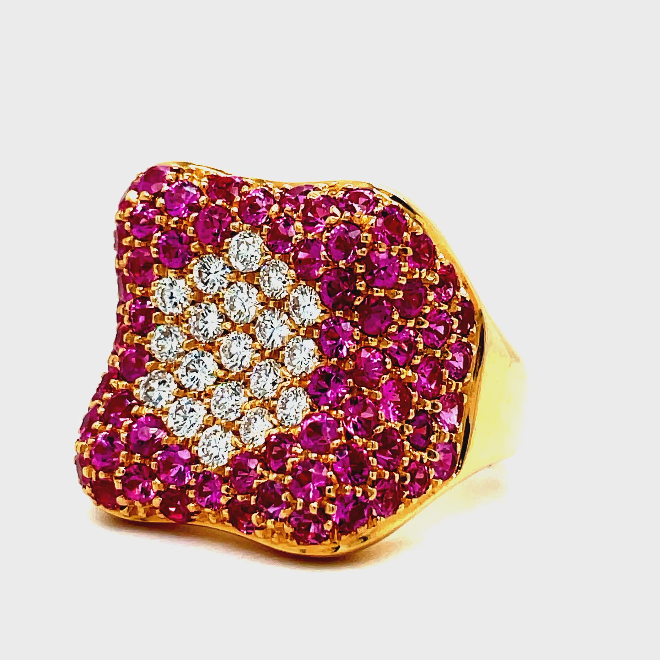 Indulge in luxury with our Italian-crafted Pink Sapphire and Diamond Pave Cocktail Wide Rose Gold Ring. Made with 18k rose gold, this wide fashion ring boasts a stunning 2.66 carats of pink sapphires and 0.50 carats of round diamonds, expertly pave-set for a glamorous and sophisticated look. Elevate your style with this exclusive and elegant piece.