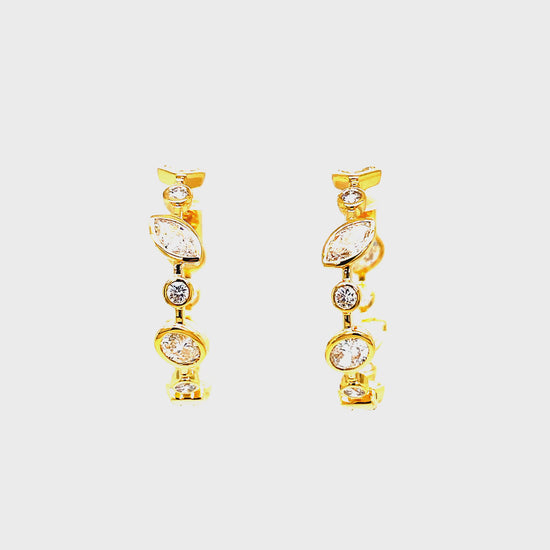 Upgrade your jewelry collection with our exclusive 18K Yellow Gold Mix Cut Bezel Set Diamond Hoop Earrings. Handcrafted with 2.14 carats of emerald, marquise, baguette, and round cut diamonds, these earrings radiate sophistication. The secure clasp system ensures durability, while the inside out diamonds add a subtle yet luxurious touch. Elevate any outfit with these elegant and timeless earrings.