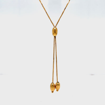 ndulge in luxury with our 14k Yellow Gold Bar &amp; Bead Lariat Necklace. Crafted from premium 14k yellow gold, this necklace features a delicate box chain, three gold beads, and a 16" length with a 2" lariat drop. Elevate your style and make a statement with this exclusive piece.