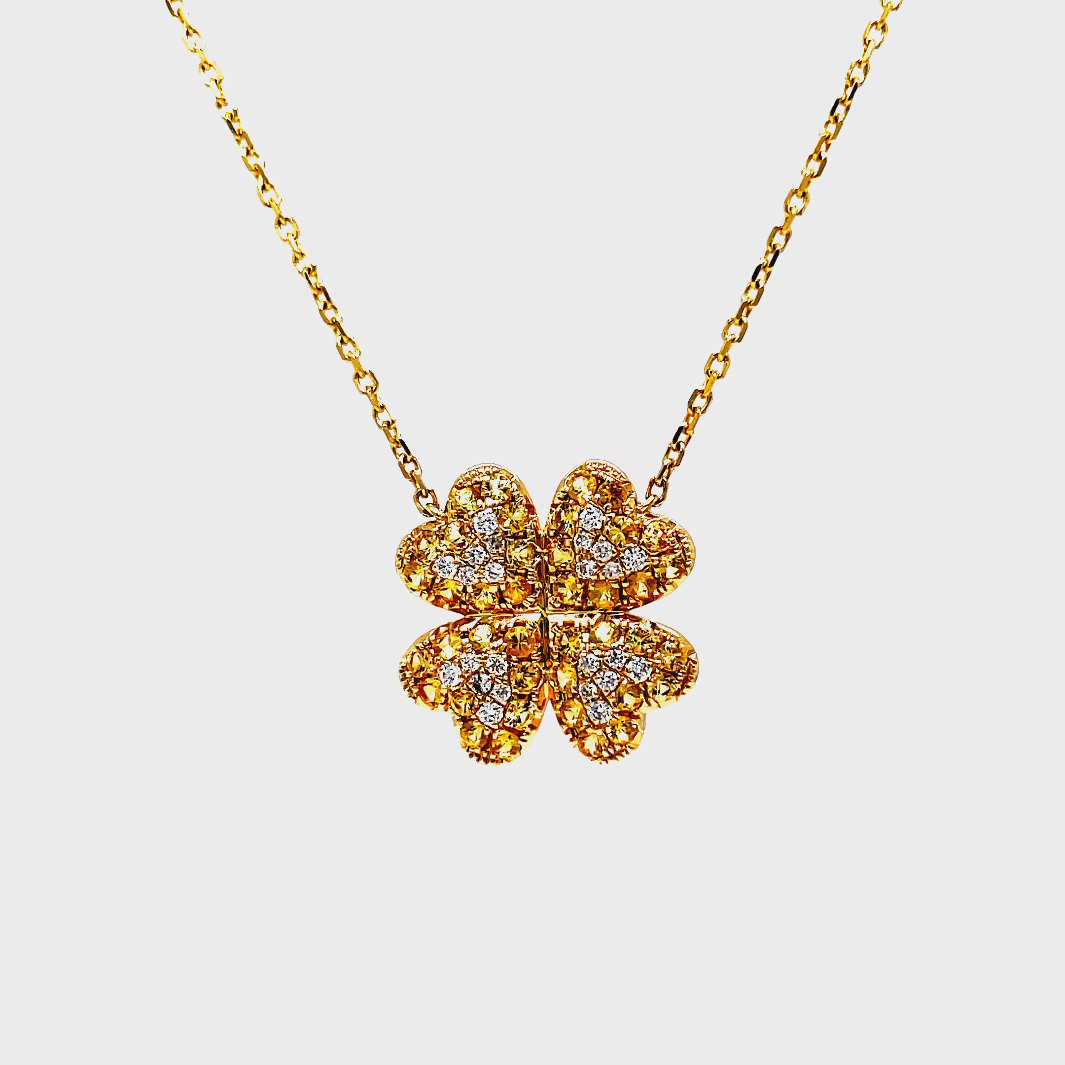 Indulge in the luxurious sophistication of our Four Petal Yellow Sapphire &amp; Diamond Pendant Necklace. Crafted with 14k yellow gold and adorned with 0.86 carats of vibrant yellow sapphires and 0.16 carats of dazzling round diamonds. Complete with a 18" chain and sizing loop at 16", this necklace is the perfect addition to any elegant ensemble.