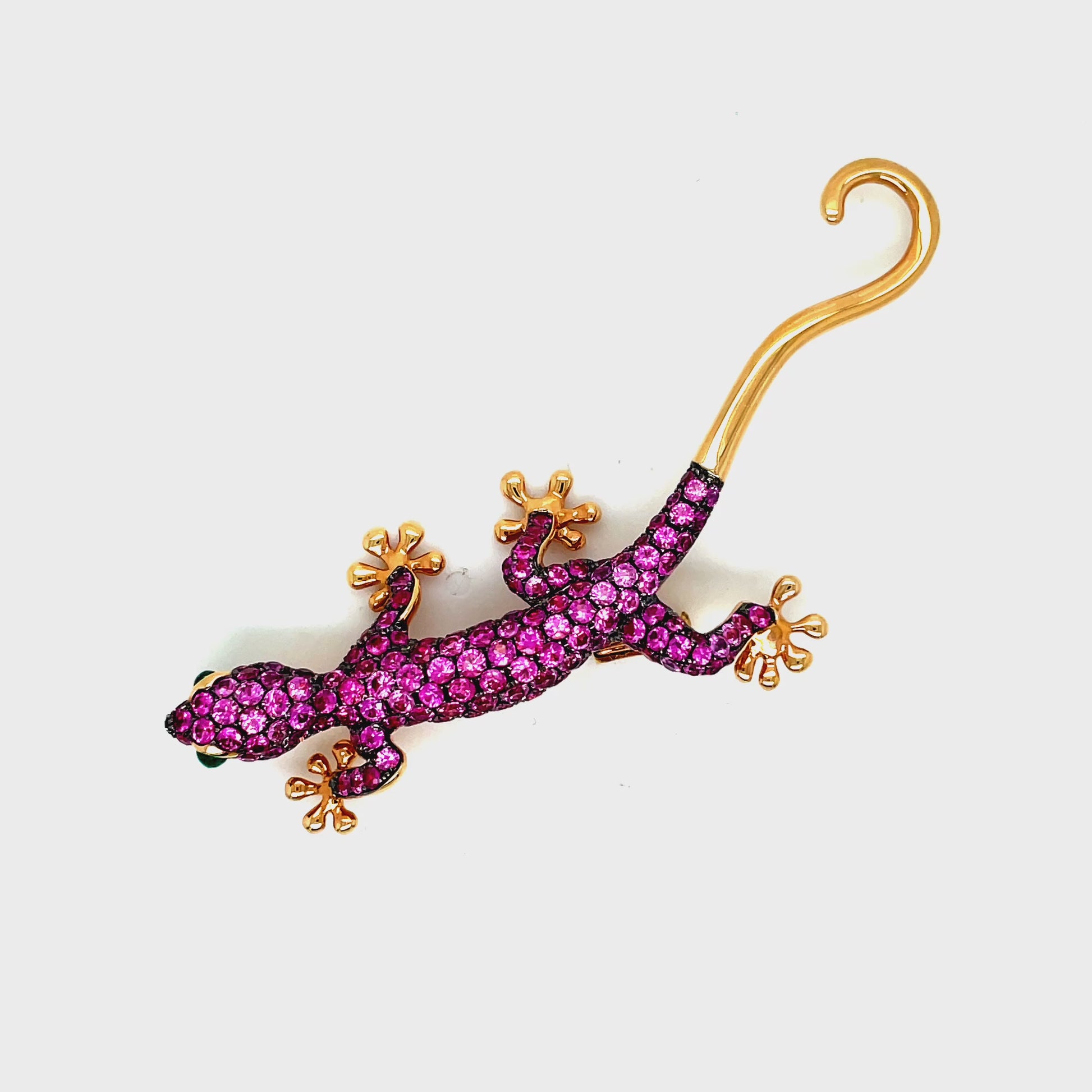 Indulge in timeless elegance with our Pink Sapphire and Emerald Lizard Brooch. Crafted from 18k rose gold, this luxurious piece features two mesmerizing emerald eyes and delicate pink sapphires. Versatile as both a pendant and brooch, this lizard adds a touch of sophistication to any outfit. Make a statement with this unique and stunning accessory.