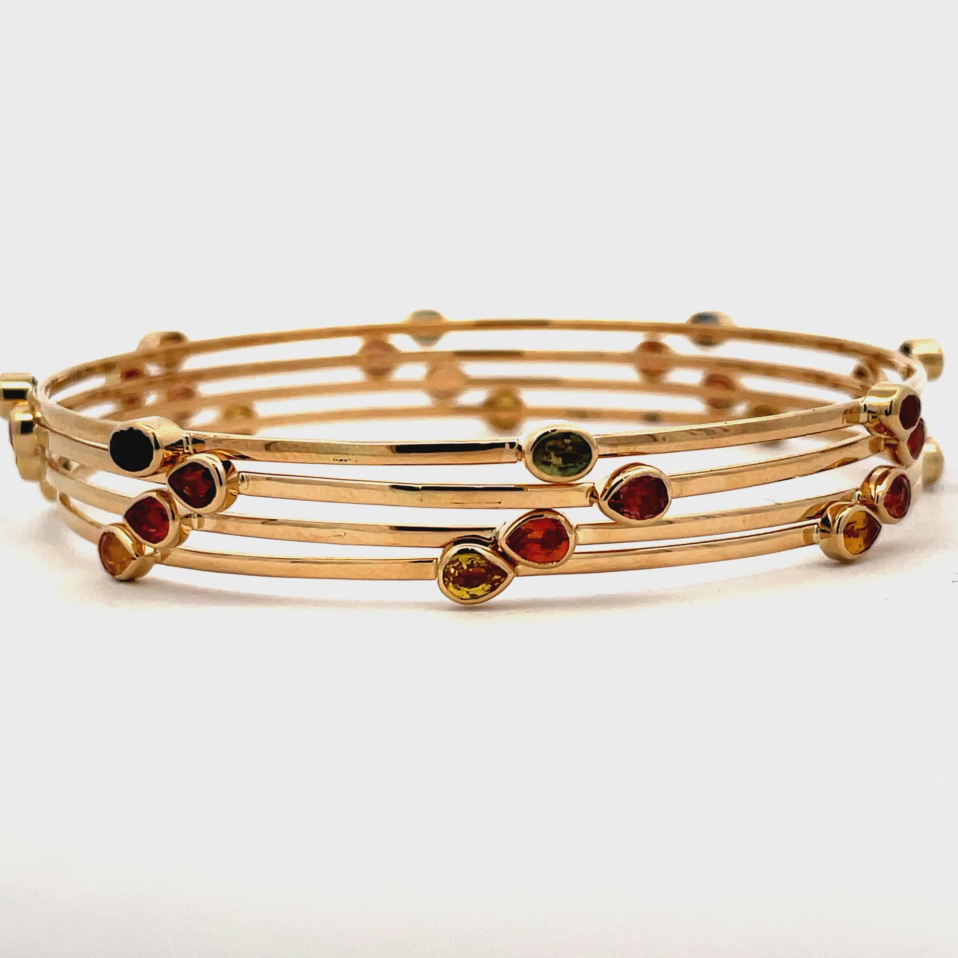 Try on video of 14k Yellow Gold Multicolor Sapphire Bangles